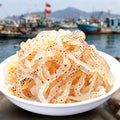 Shredded translucent jellyfish strips with sesame in a bowl